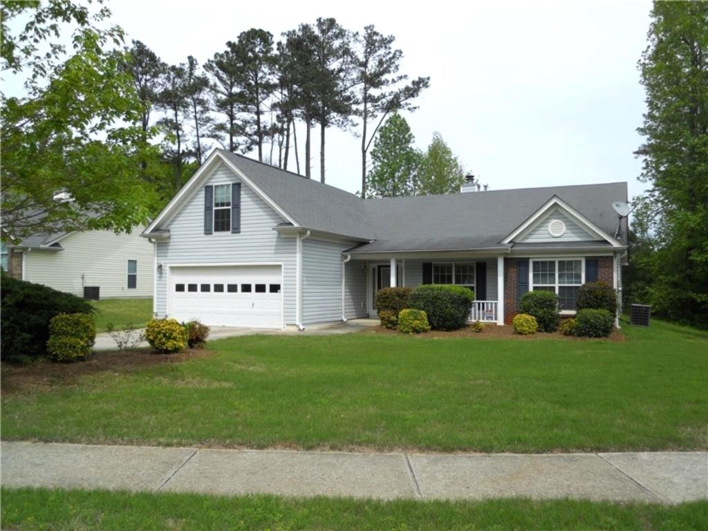 301 Yarbrough Court Dacula, GA 30019 - Photo 1 of 11 a front view of a house with a yard and garage