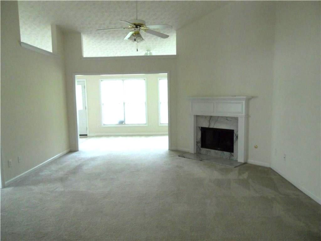301 Yarbrough Court Dacula, GA 30019 - Photo 2 of 11 a view of empty room with a fireplace