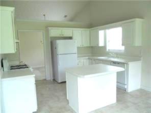 301 Yarbrough Court Dacula, GA 30019 - Photo 5 of 11 a kitchen with a sink a stove and a refrigerator