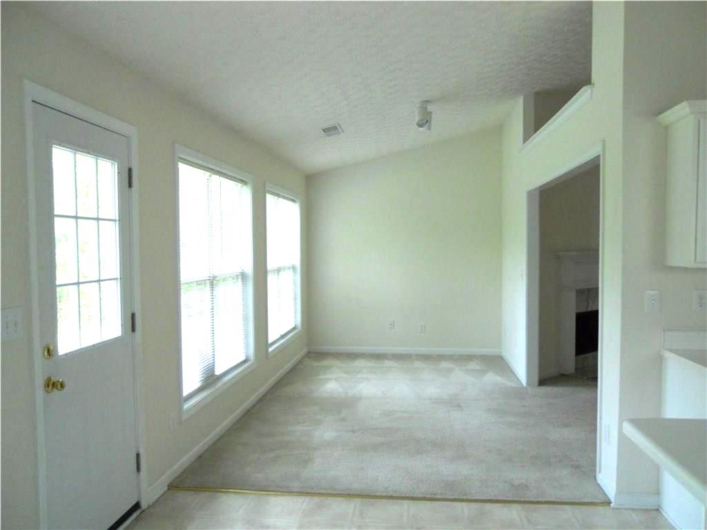 301 Yarbrough Court Dacula, GA 30019 - Photo 6 of 11 a view of an empty room with a window