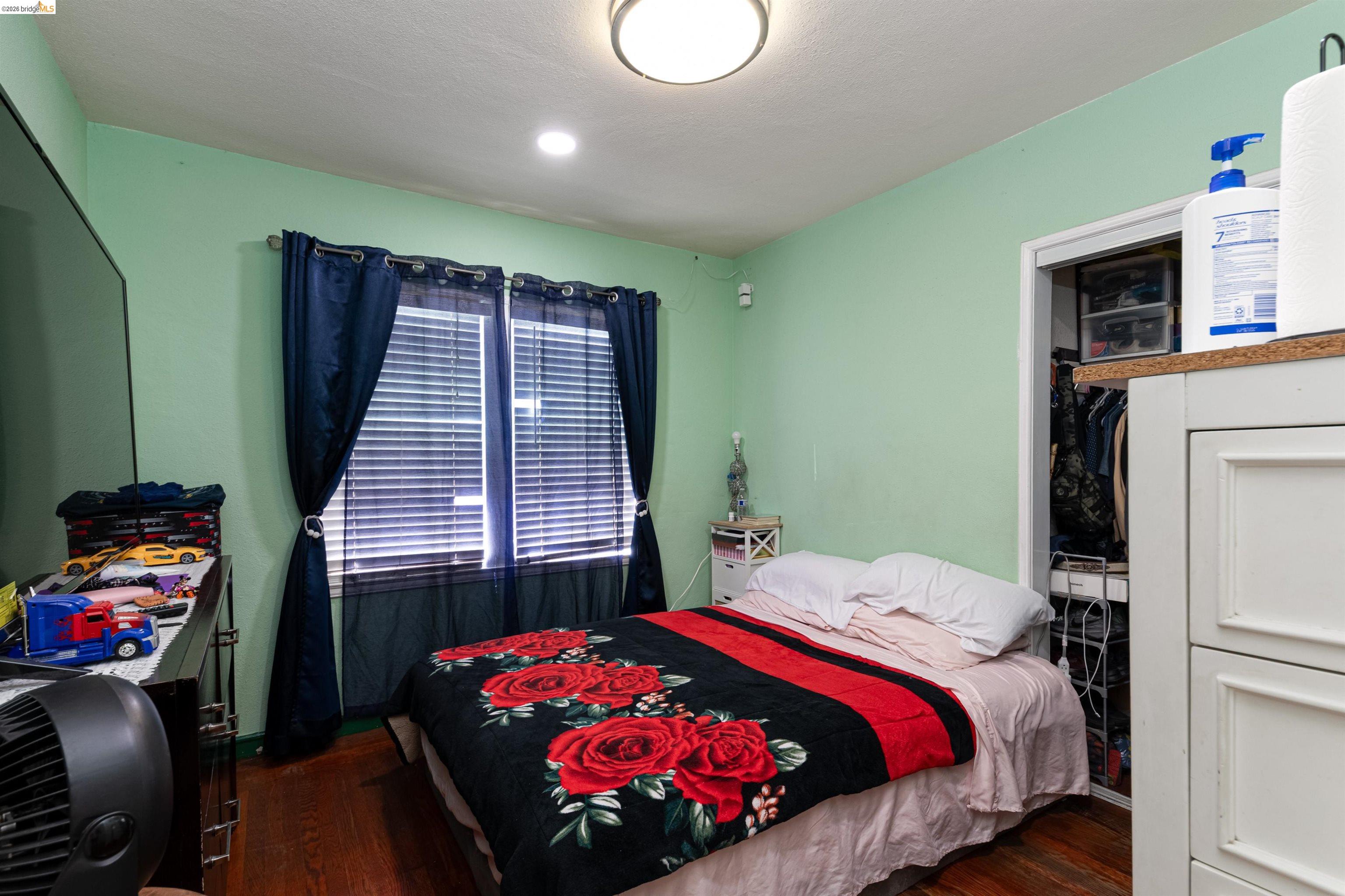 1821 74th Avenue Oakland, CA 94621 - Photo 9 of 27 Bedroom featuring dark wood finished floors and a closet