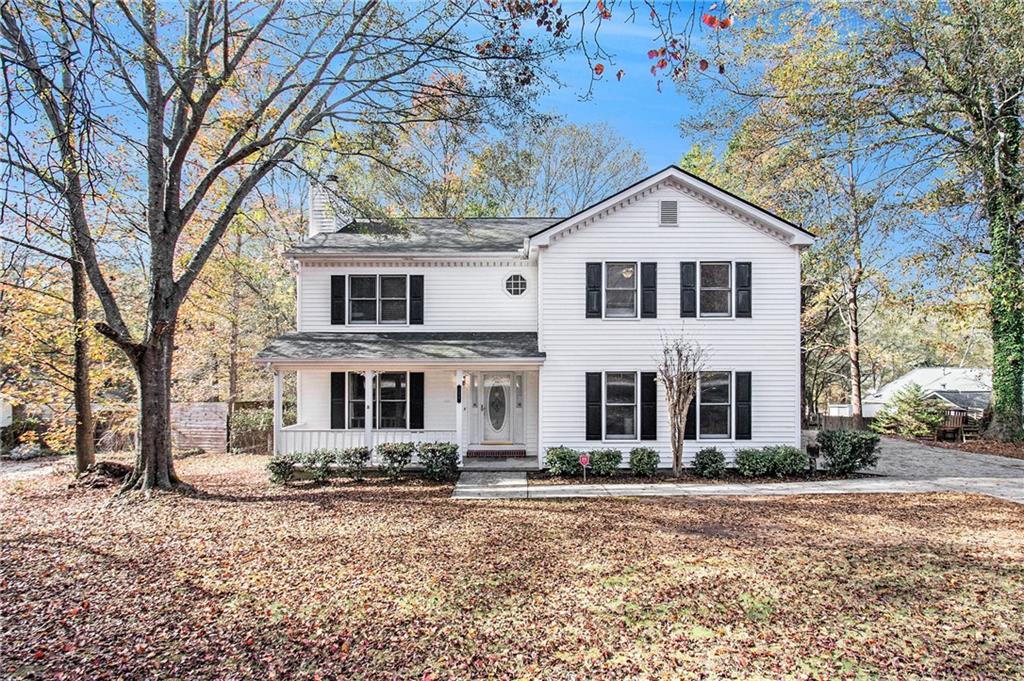 236 Ryan Road Winder, GA 30680 - Photo 1 of 1 a front view of a house with garden and trees