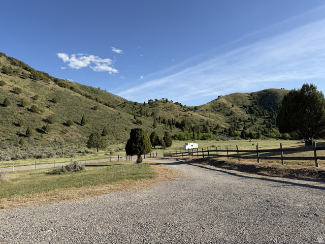 2006 Swenson Valley Road Bancroft, ID 83217 - Photo 29 of 51 Expansive mountain-backed property featuring a gravel driveway and partial wood fencing