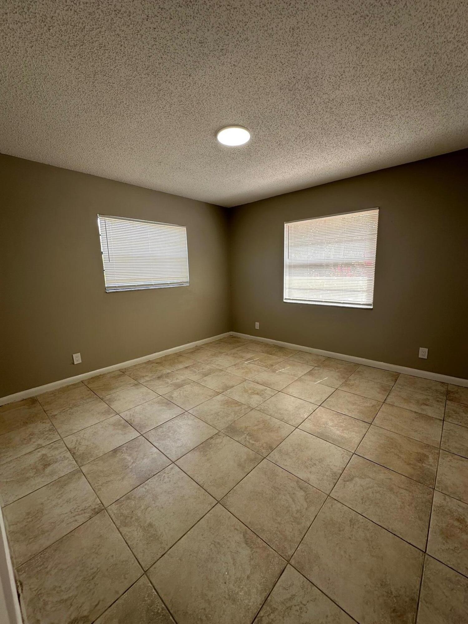4810 Davis Road, Unit 4818 Lake Worth, FL 33461 - Photo 6 of 12 a view of an empty room and a window