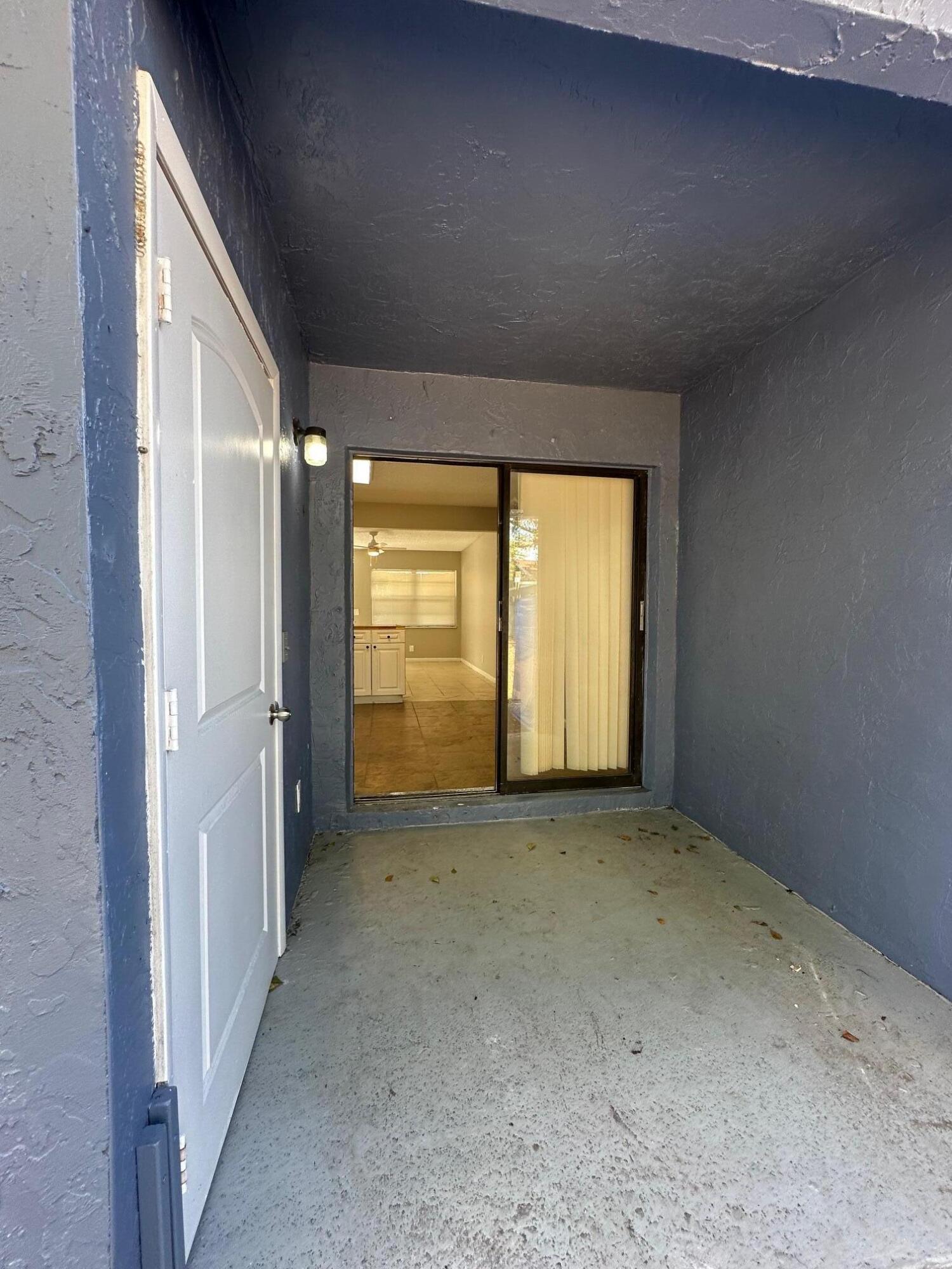 4810 Davis Road, Unit 4818 Lake Worth, FL 33461 - Photo 10 of 12 an empty room with windows