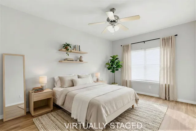 a bedroom with a large bed and a chandelier