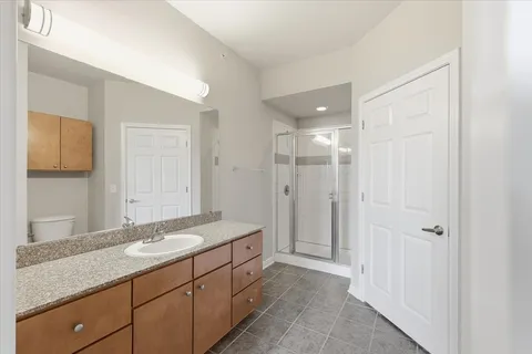 a bathroom with a granite countertop sink mirror and double