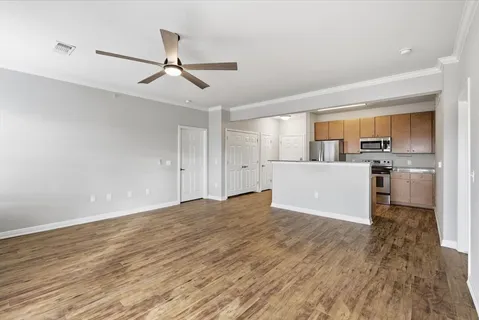 a view of a kitchen with a sink cabinets and wooden floor