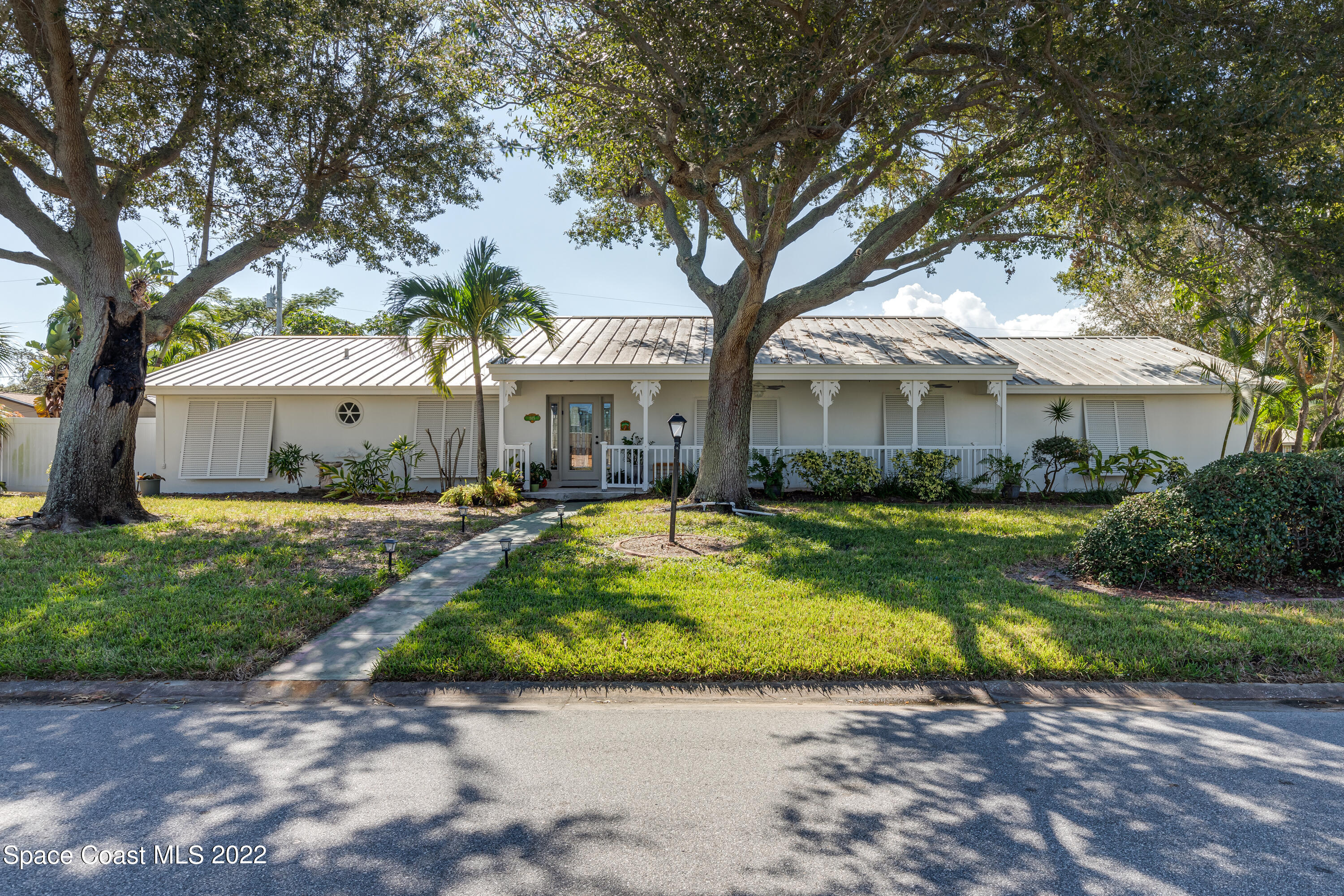 515 Oak Ridge Drive Indialantic, FL 32903 - Photo 1 of 34 a view of a house with swimming pool and a large tree