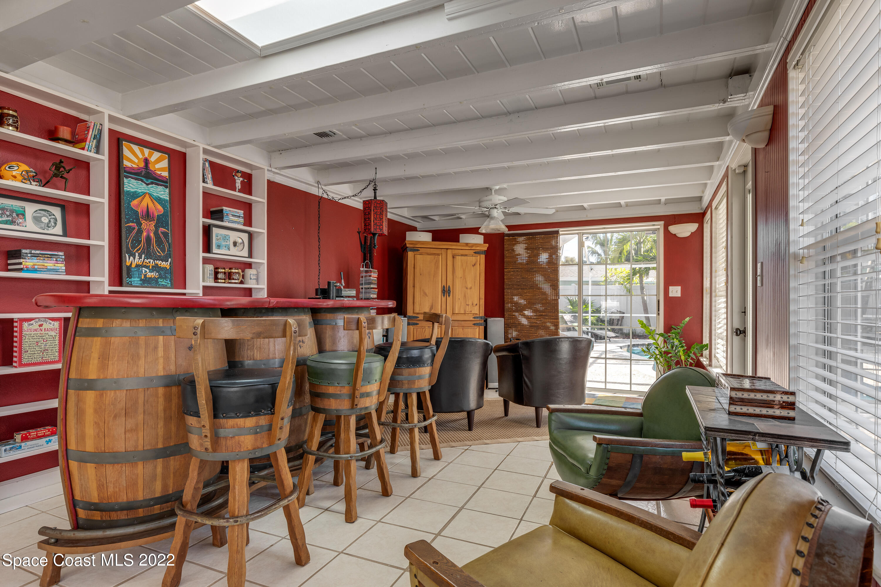 515 Oak Ridge Drive Indialantic, FL 32903 - Photo 13 of 34 a living room with furniture a rug and white walls
