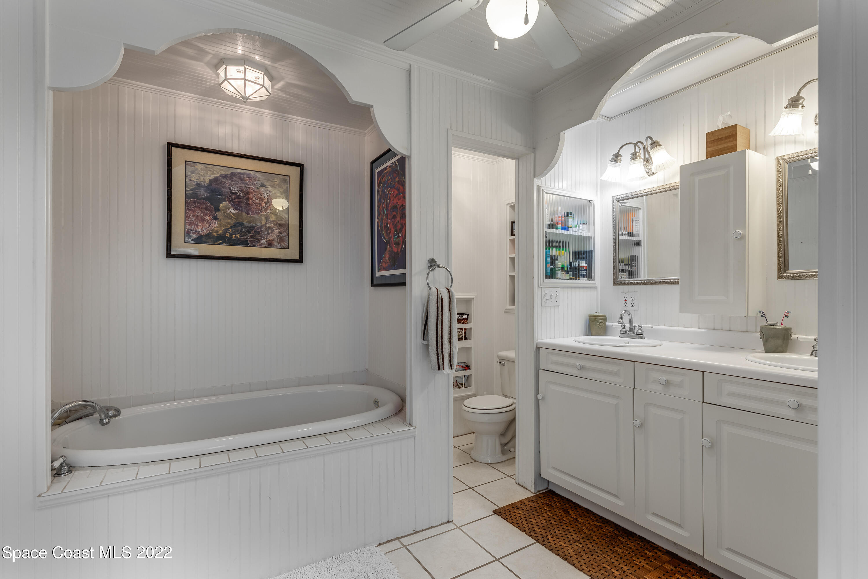 515 Oak Ridge Drive Indialantic, FL 32903 - Photo 16 of 34 a bathroom with a bathtub shower sink mirror and toilet