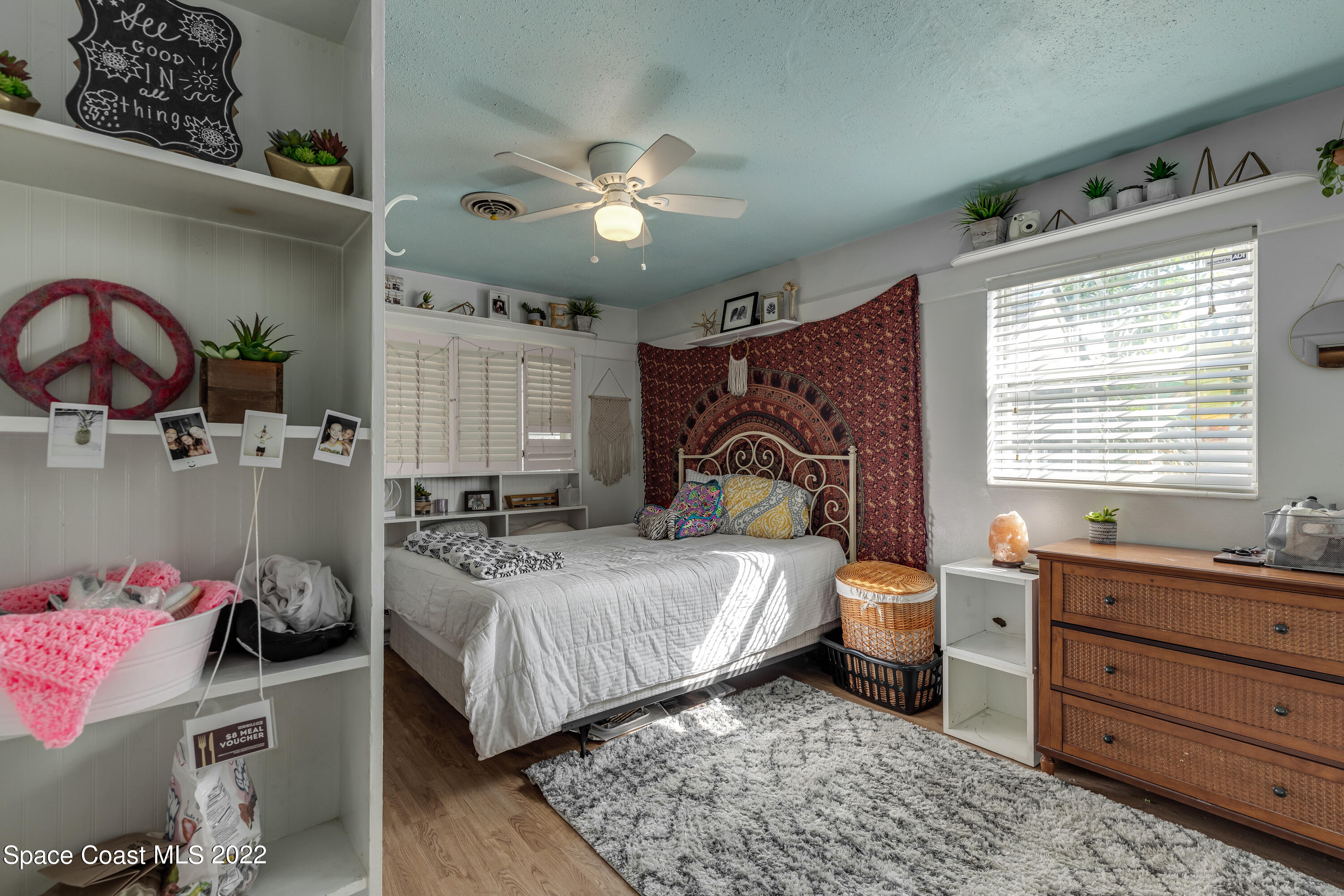 515 Oak Ridge Drive Indialantic, FL 32903 - Photo 17 of 34 a bedroom with a bed and a chandelier