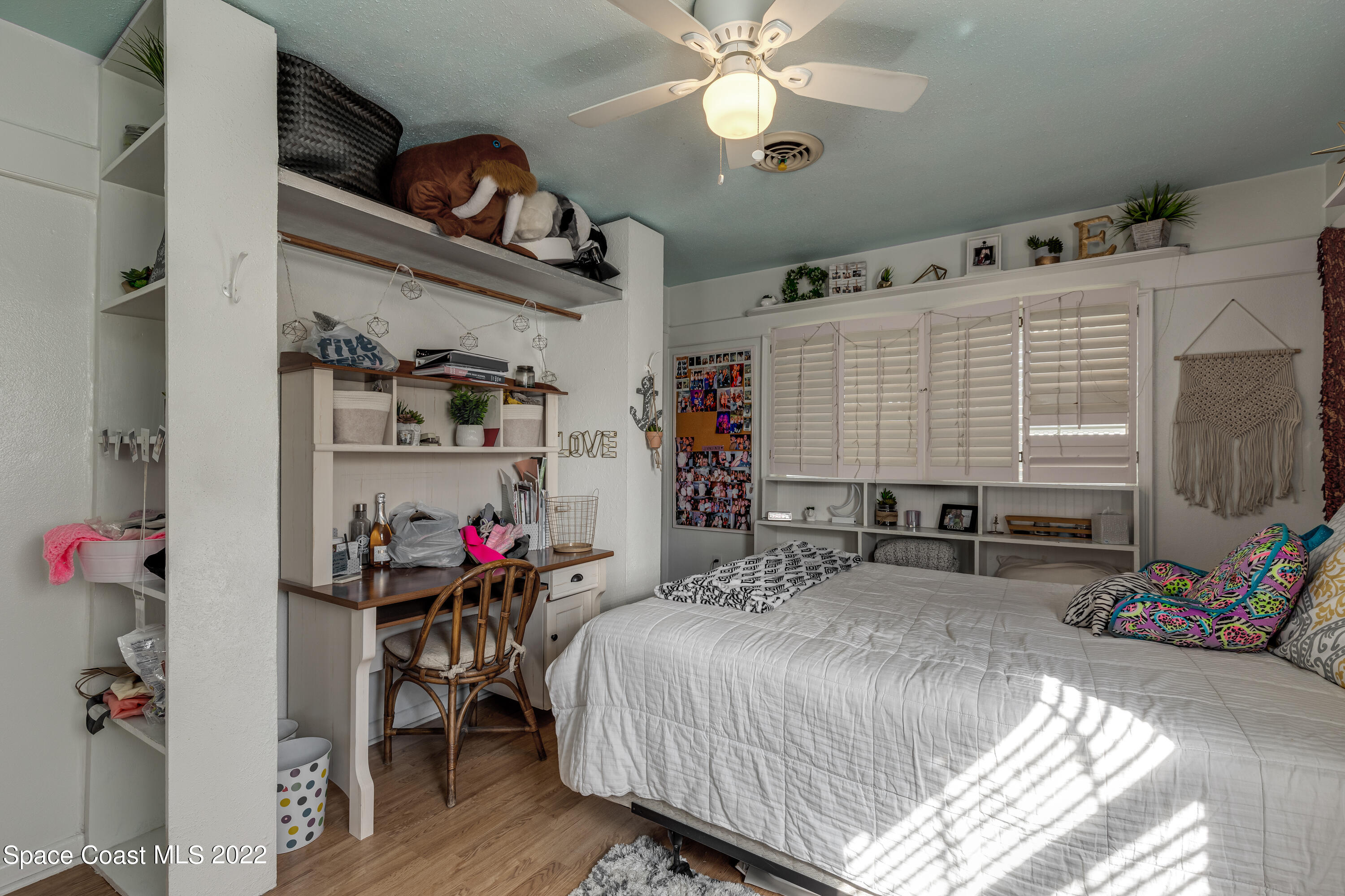 515 Oak Ridge Drive Indialantic, FL 32903 - Photo 18 of 34 a bedroom with a bed and a chandelier