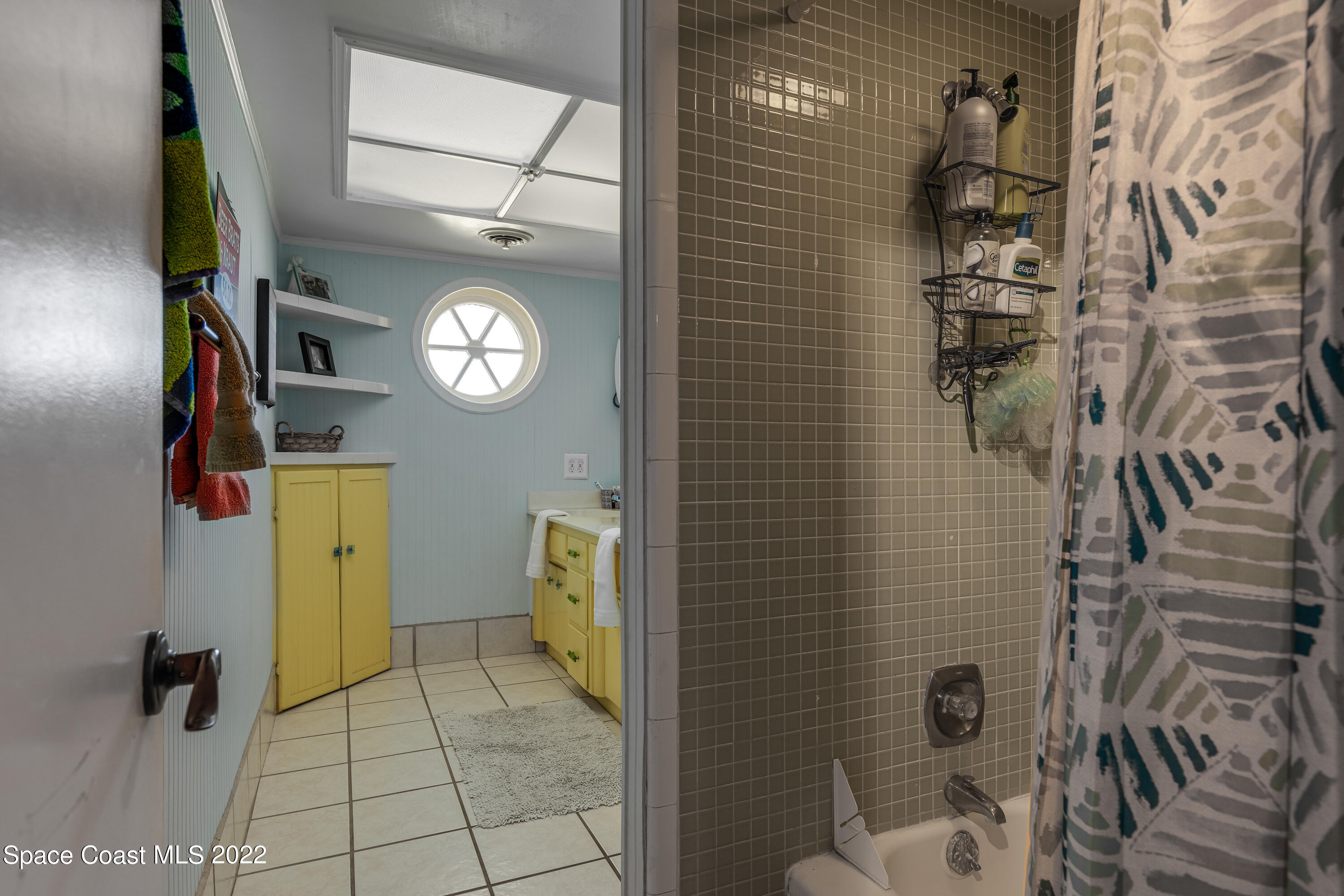 515 Oak Ridge Drive Indialantic, FL 32903 - Photo 20 of 34 a bathroom with a toilet and a shower curtain