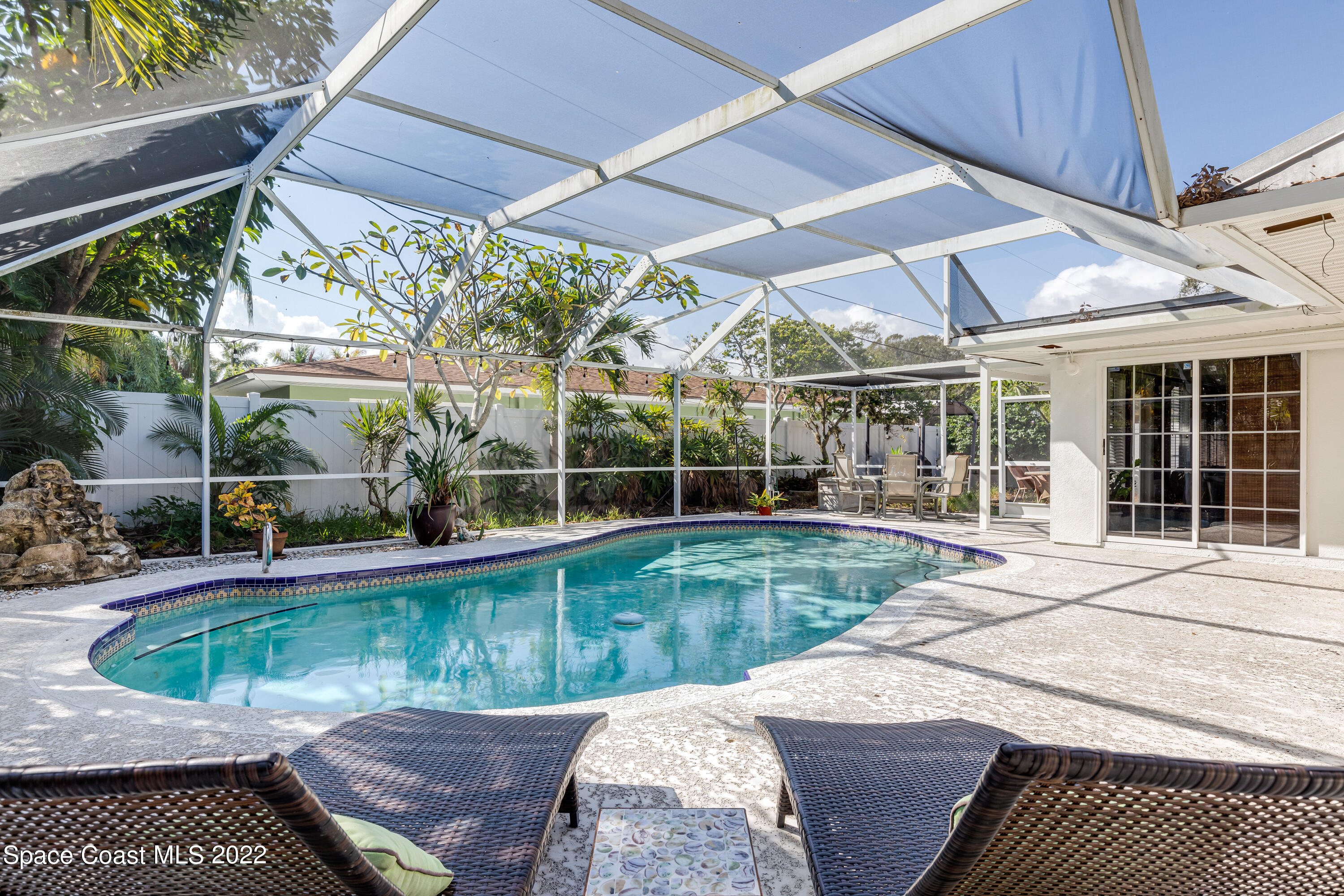 515 Oak Ridge Drive Indialantic, FL 32903 - Photo 23 of 34 a view of a swimming pool with a patio
