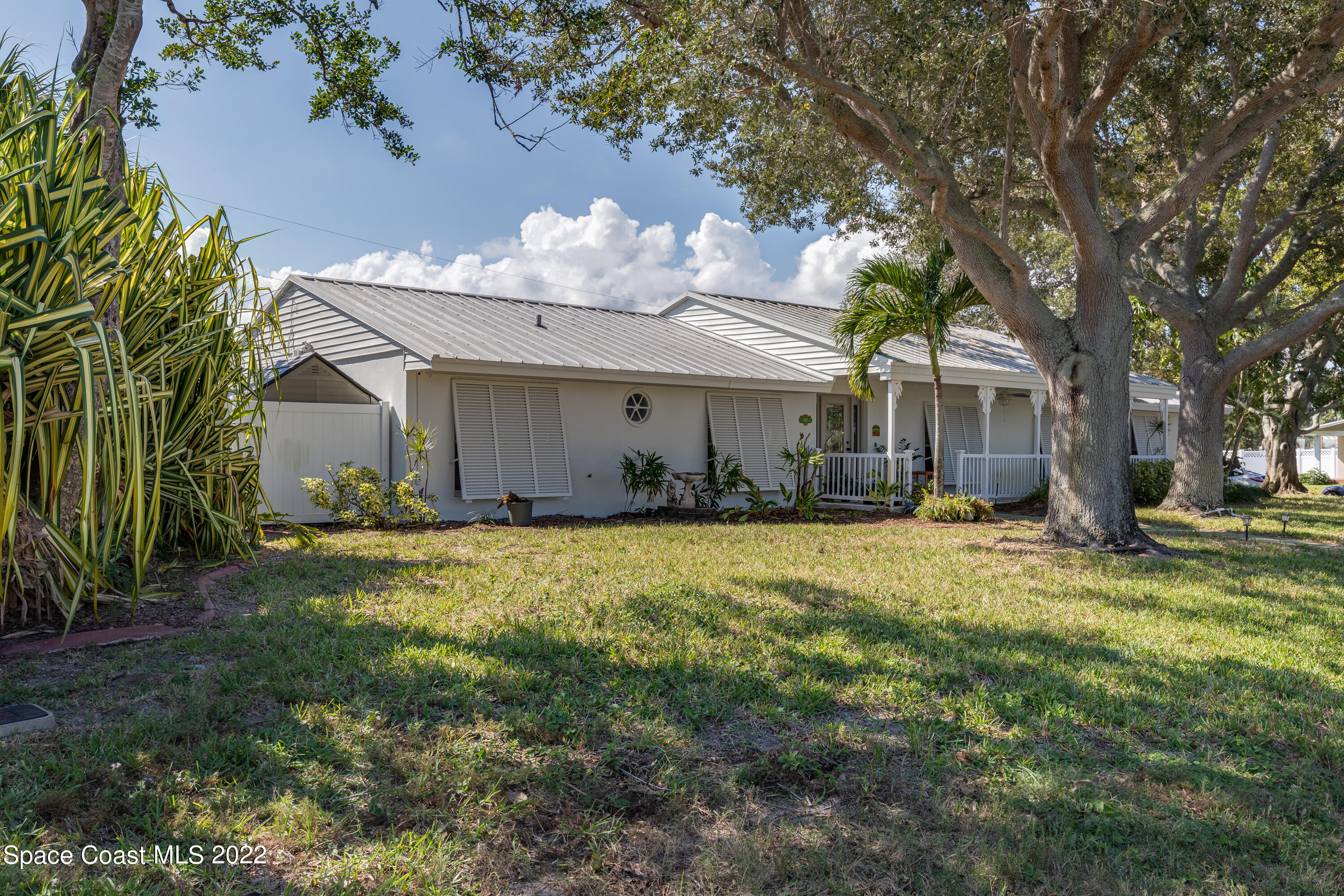 515 Oak Ridge Drive Indialantic, FL 32903 - Photo 3 of 34 a front view of a house with a yard and garage