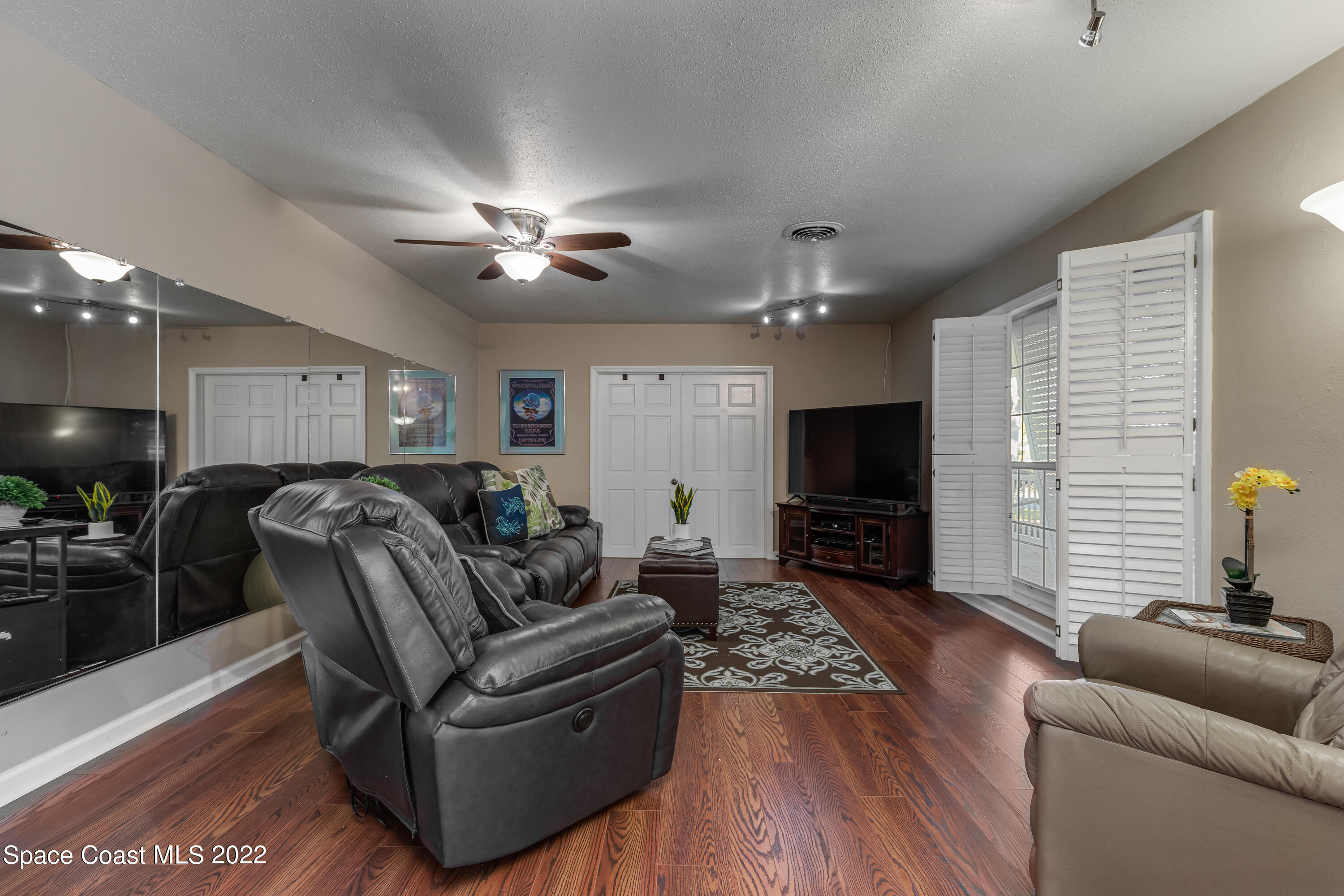 515 Oak Ridge Drive Indialantic, FL 32903 - Photo 8 of 34 a living room with furniture and a flat screen tv