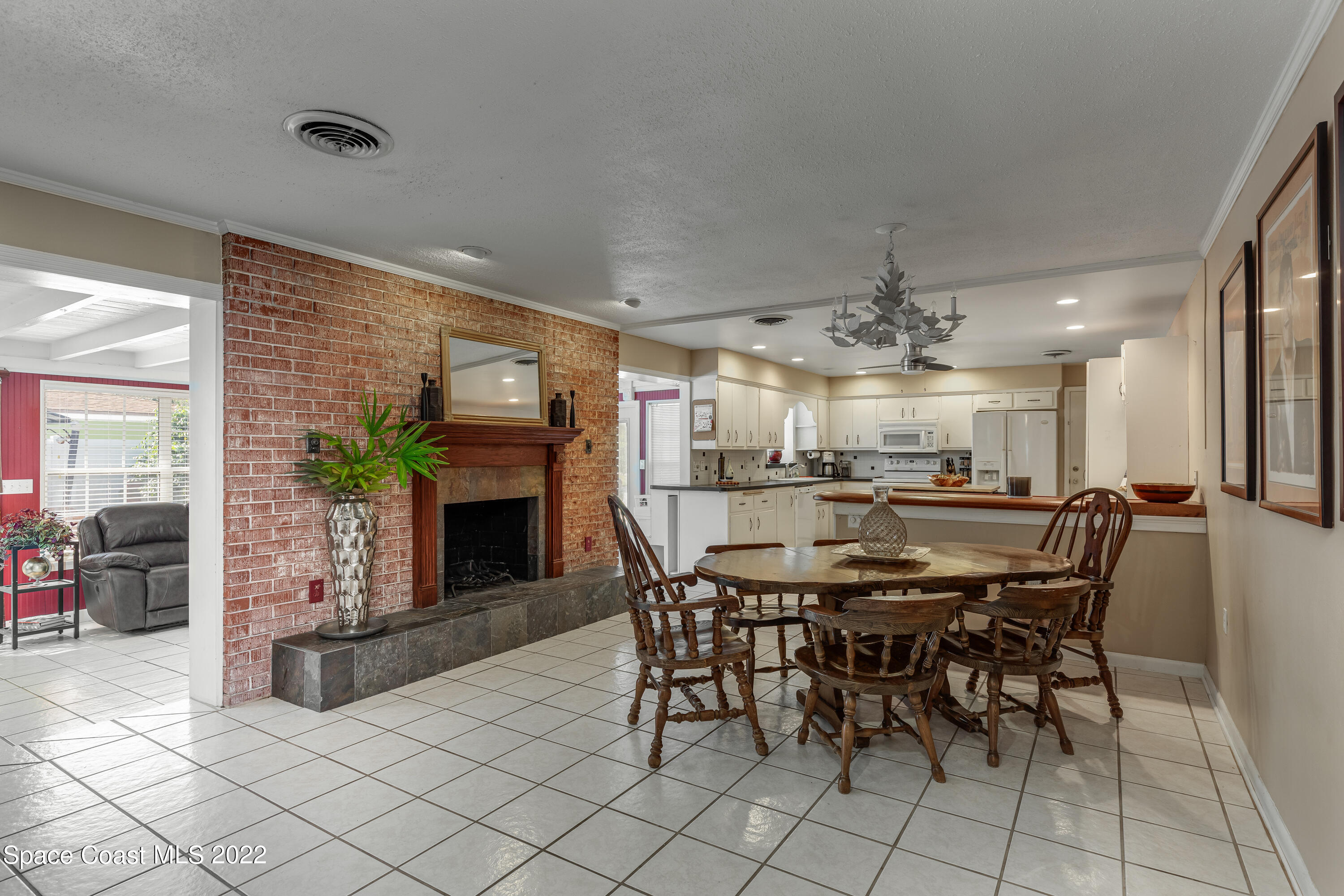 515 Oak Ridge Drive Indialantic, FL 32903 - Photo 9 of 34 a dining room with furniture and a fireplace