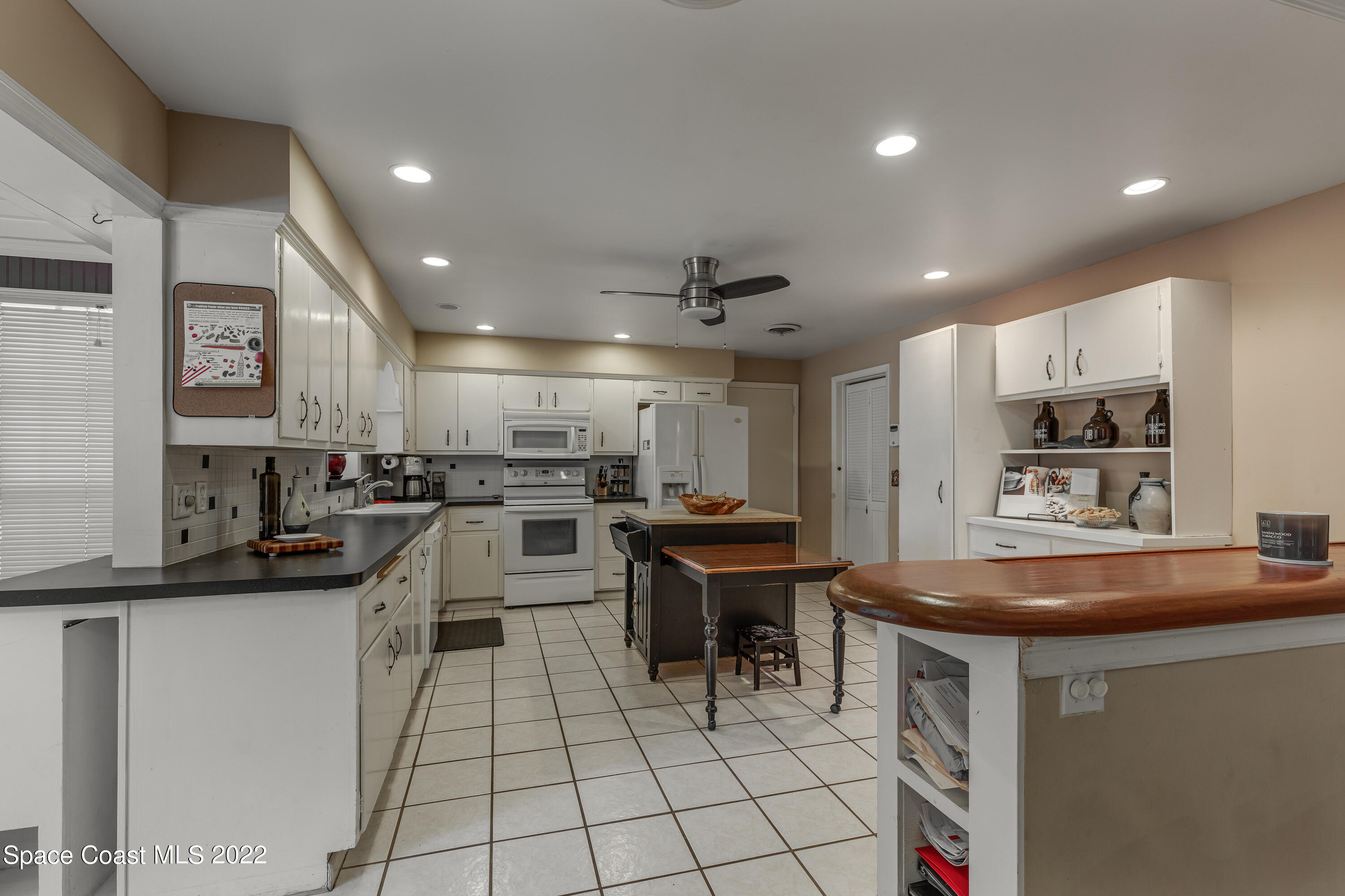 515 Oak Ridge Drive Indialantic, FL 32903 - Photo 10 of 34 a kitchen with counter top space appliances and cabinets