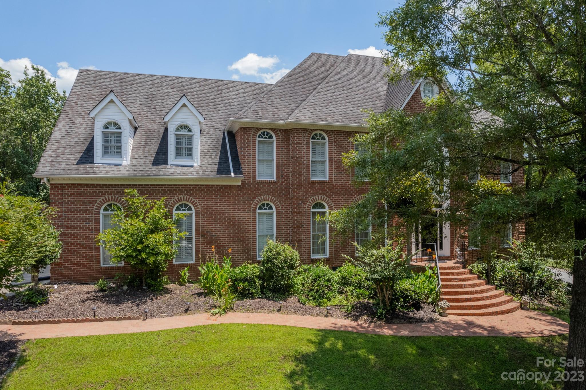 1439 Windy Ridge Road Charlotte, NC 28270 - Photo 1 of 46 a view of a house with a yard plants and large tree
