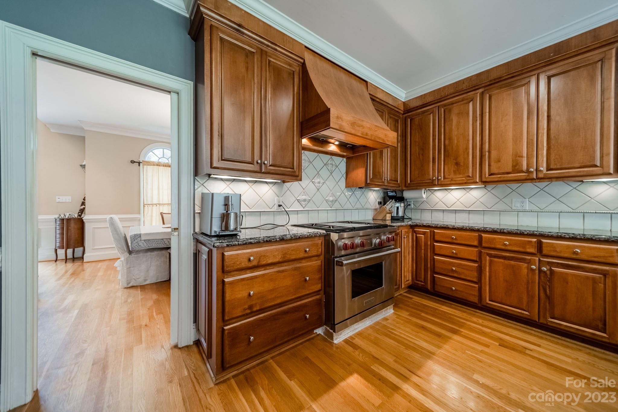 1439 Windy Ridge Road Charlotte, NC 28270 - Photo 11 of 46 a kitchen with stainless steel appliances granite countertop a stove a sink and a refrigerator