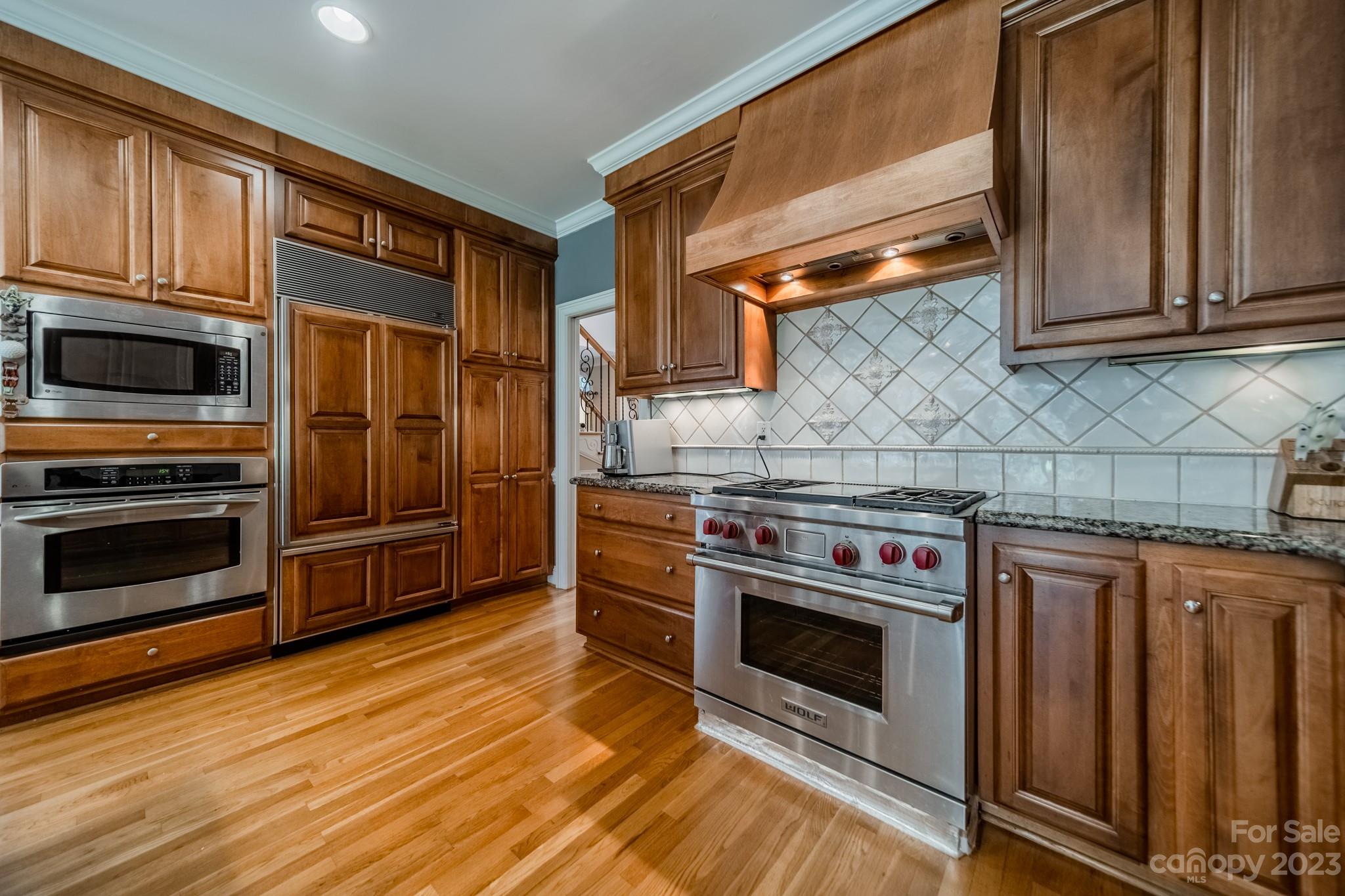 1439 Windy Ridge Road Charlotte, NC 28270 - Photo 12 of 46 a kitchen with stainless steel appliances a stove a microwave and cabinets