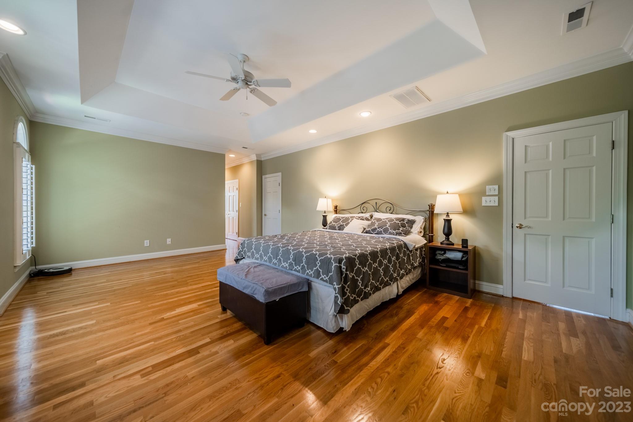 1439 Windy Ridge Road Charlotte, NC 28270 - Photo 25 of 46 a bedroom with a bed and a chandelier