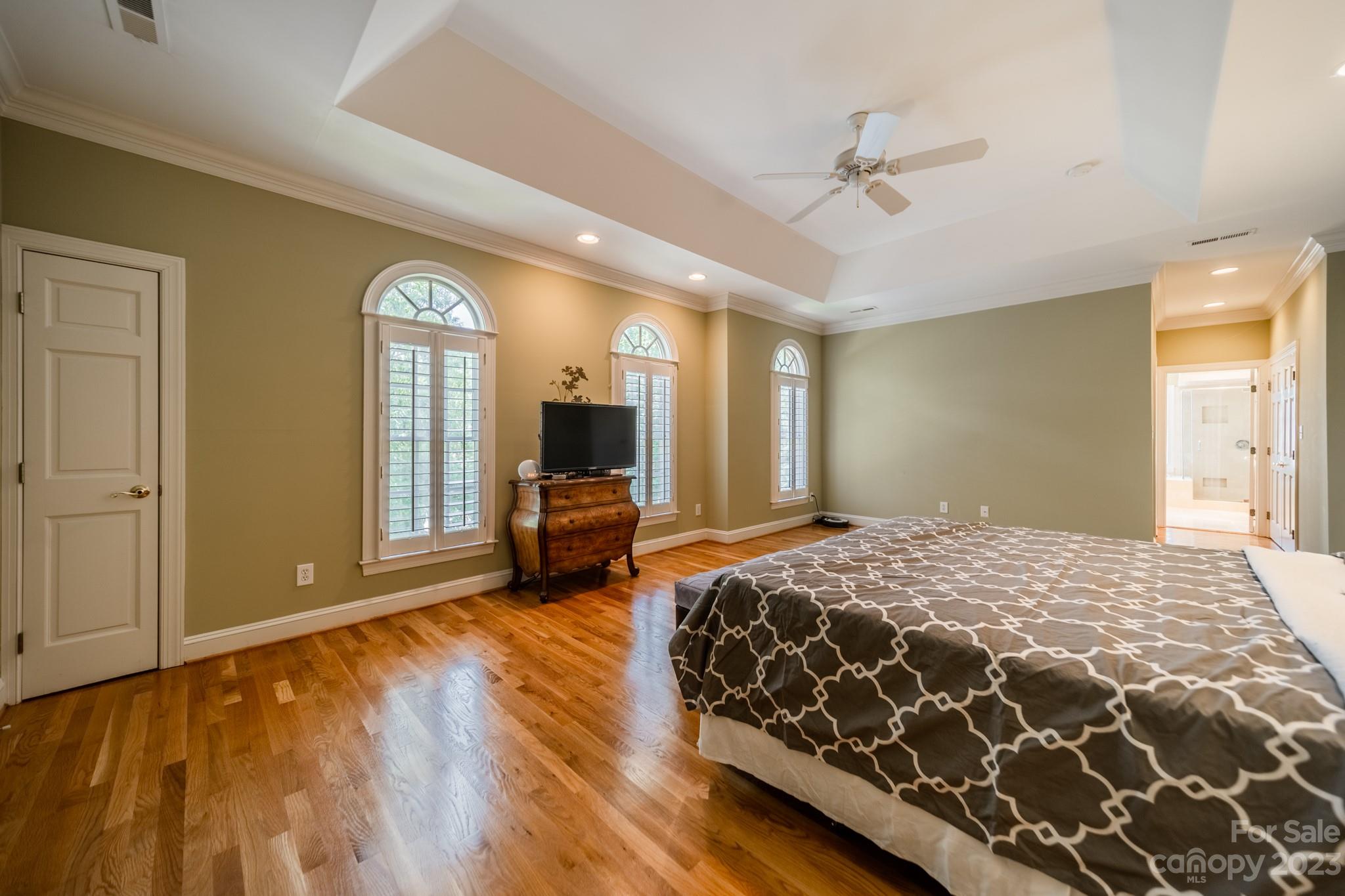 1439 Windy Ridge Road Charlotte, NC 28270 - Photo 26 of 46 a spacious bedroom with a bed and a flat screen tv