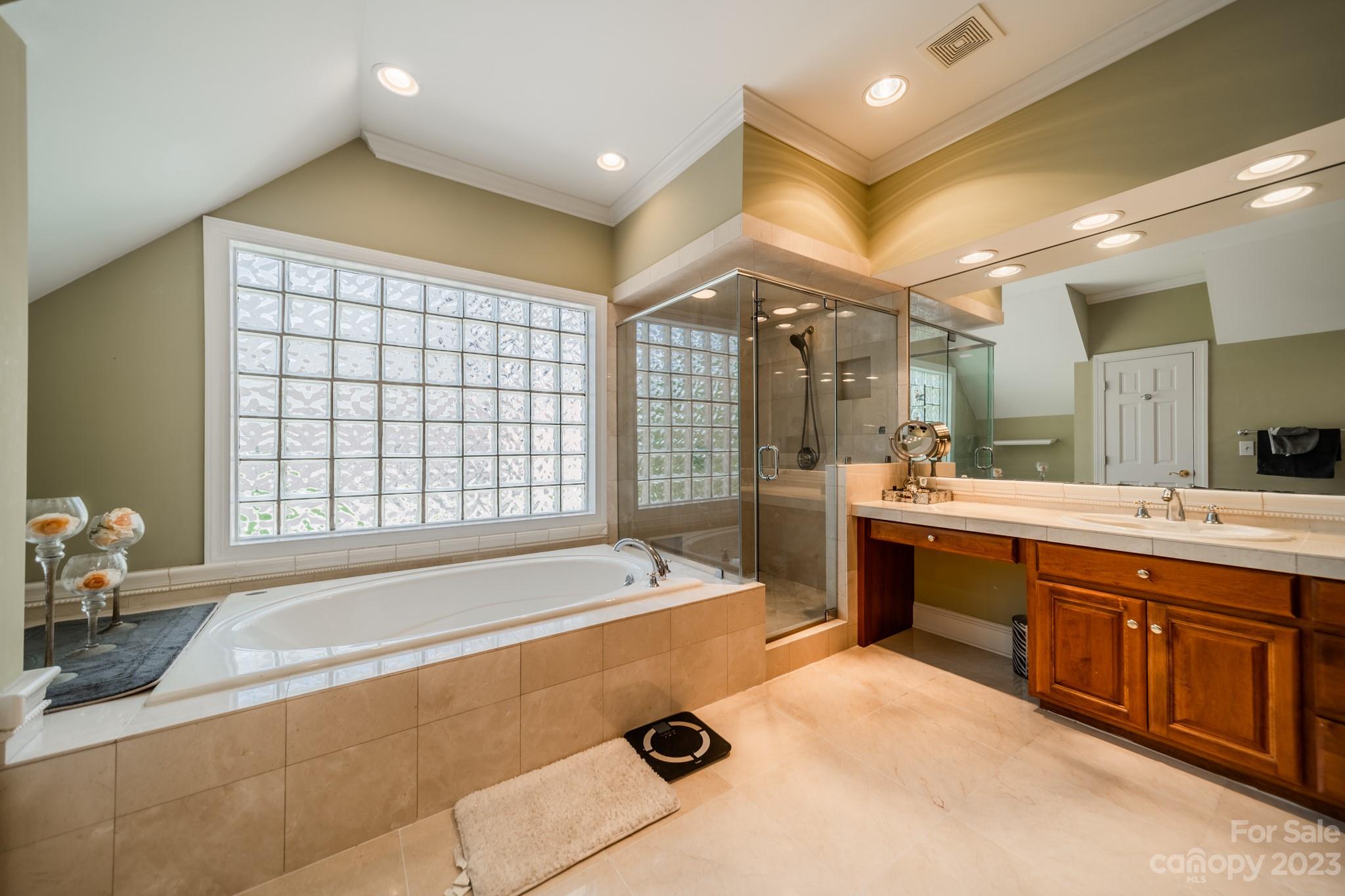 1439 Windy Ridge Road Charlotte, NC 28270 - Photo 27 of 46 a spacious bathroom with a tub sink and mirror
