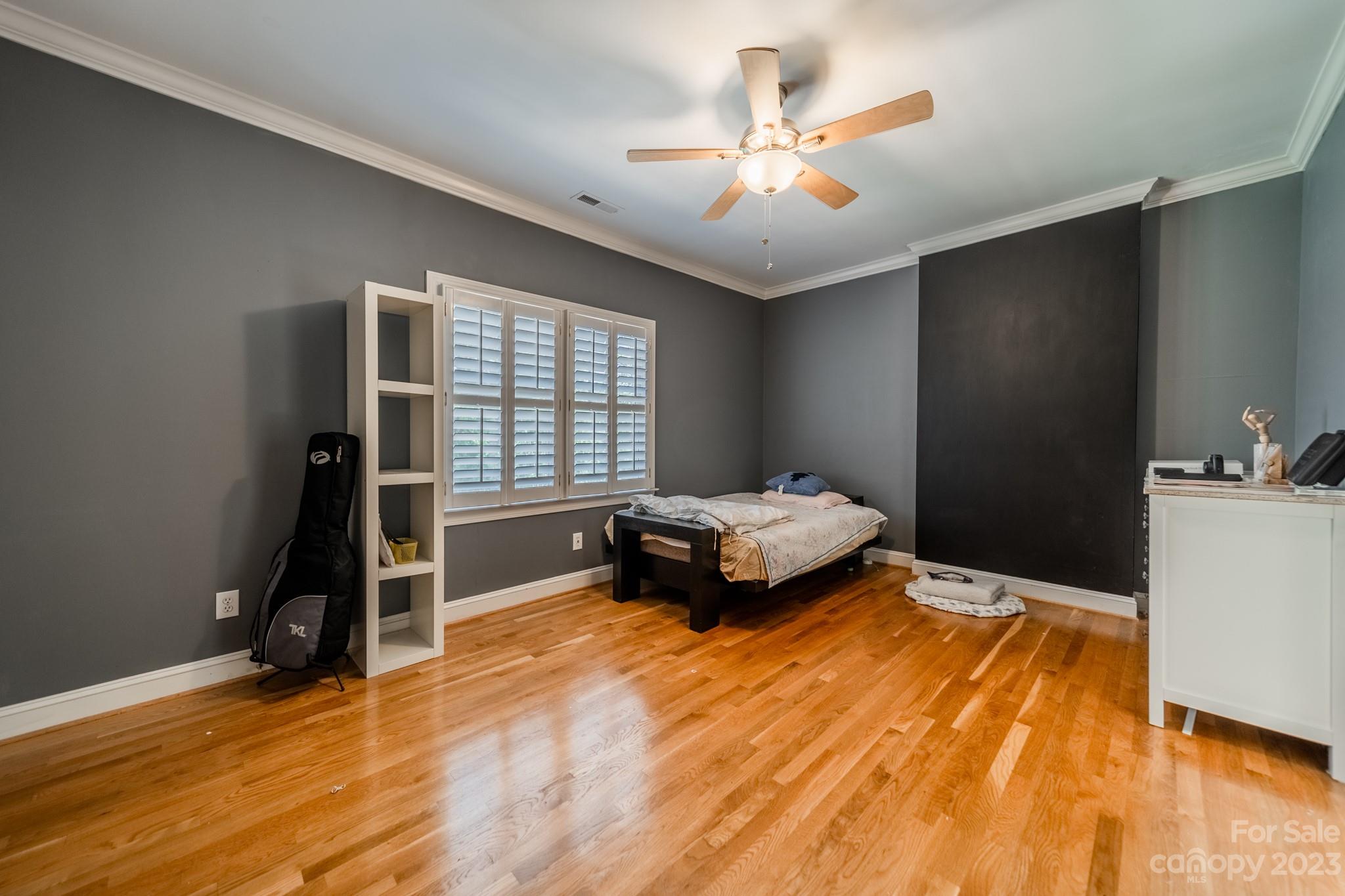 1439 Windy Ridge Road Charlotte, NC 28270 - Photo 29 of 46 a bedroom with a bed and a chandelier