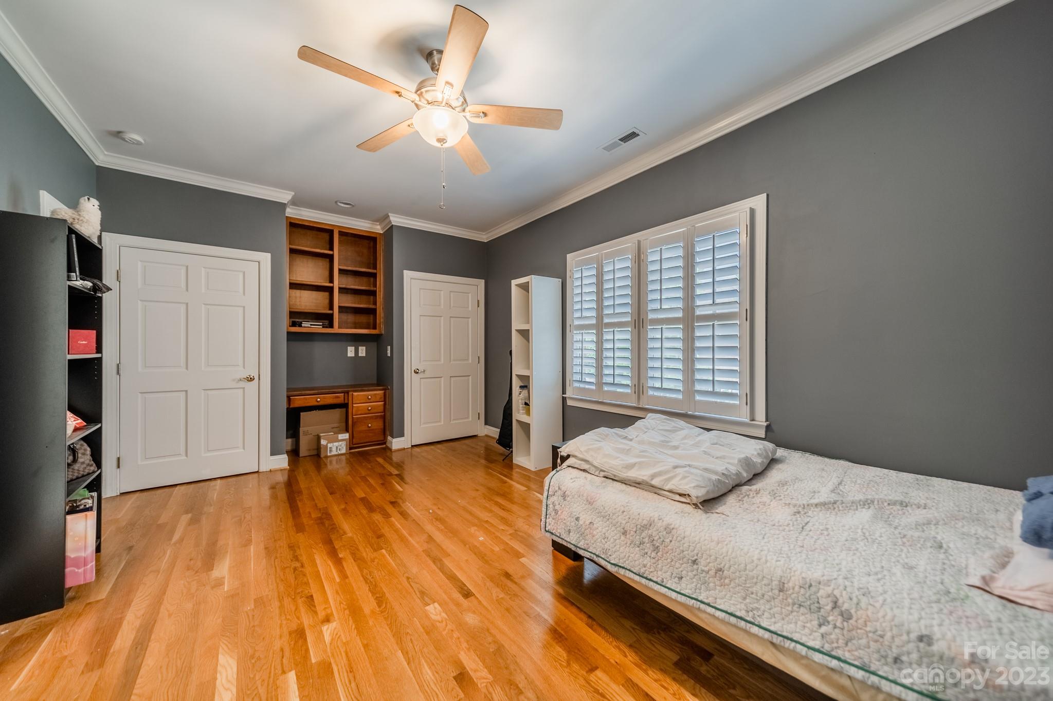 1439 Windy Ridge Road Charlotte, NC 28270 - Photo 30 of 46 a spacious bedroom with a bed and a chandelier