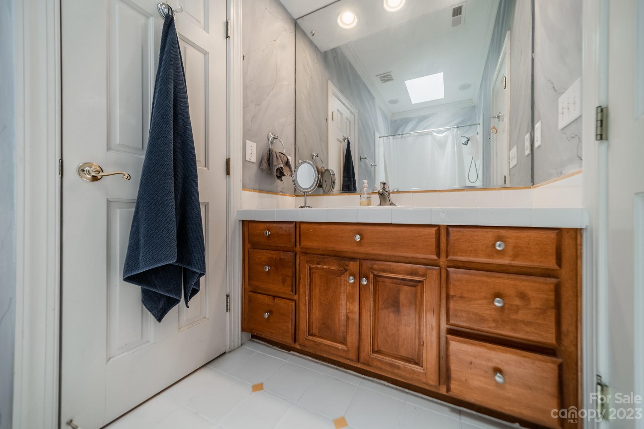 1439 Windy Ridge Road Charlotte, NC 28270 - Photo 36 of 46 a bathroom with a sink and a mirror