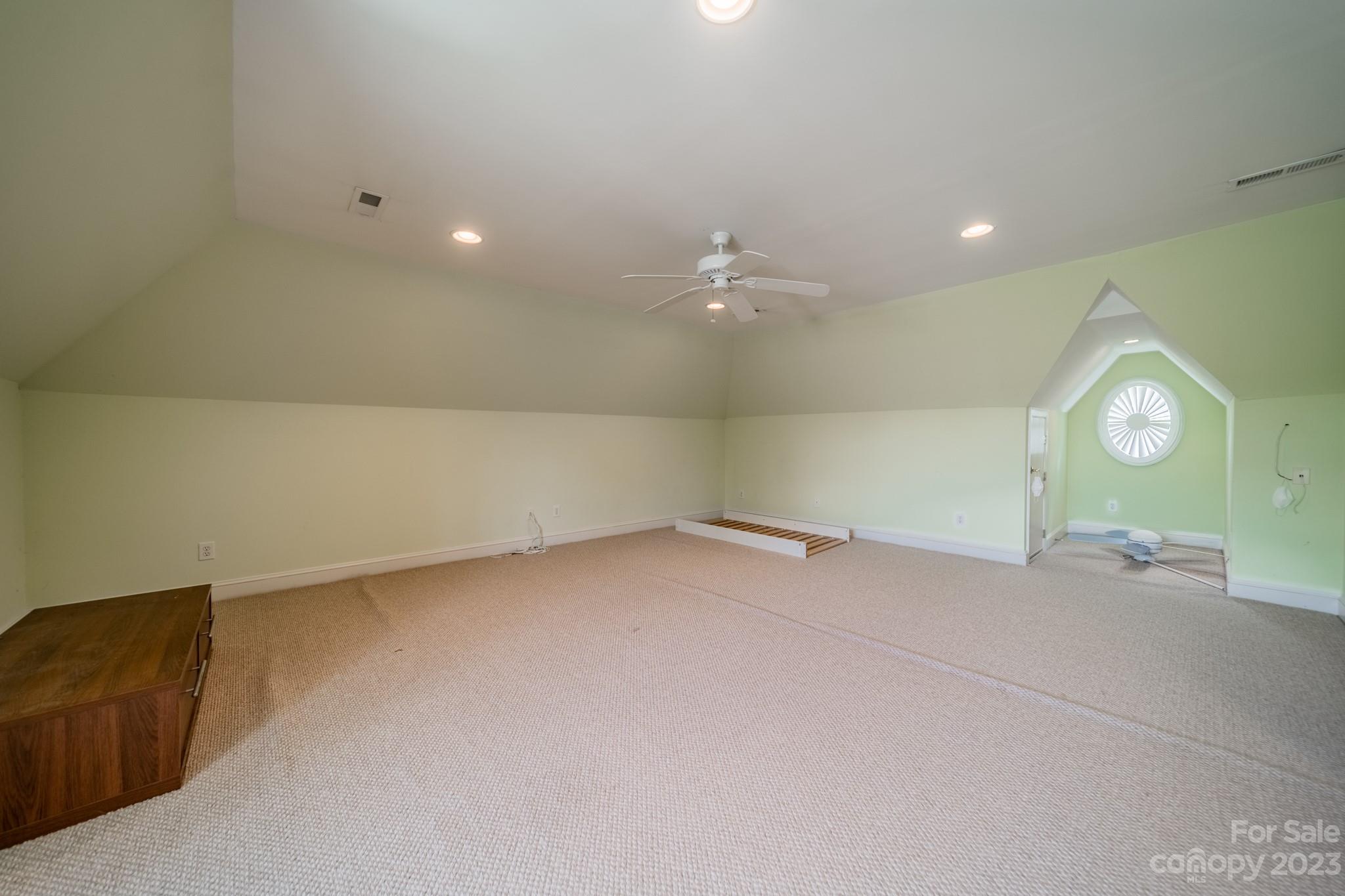 1439 Windy Ridge Road Charlotte, NC 28270 - Photo 37 of 46 an empty room with a mirror and a fan
