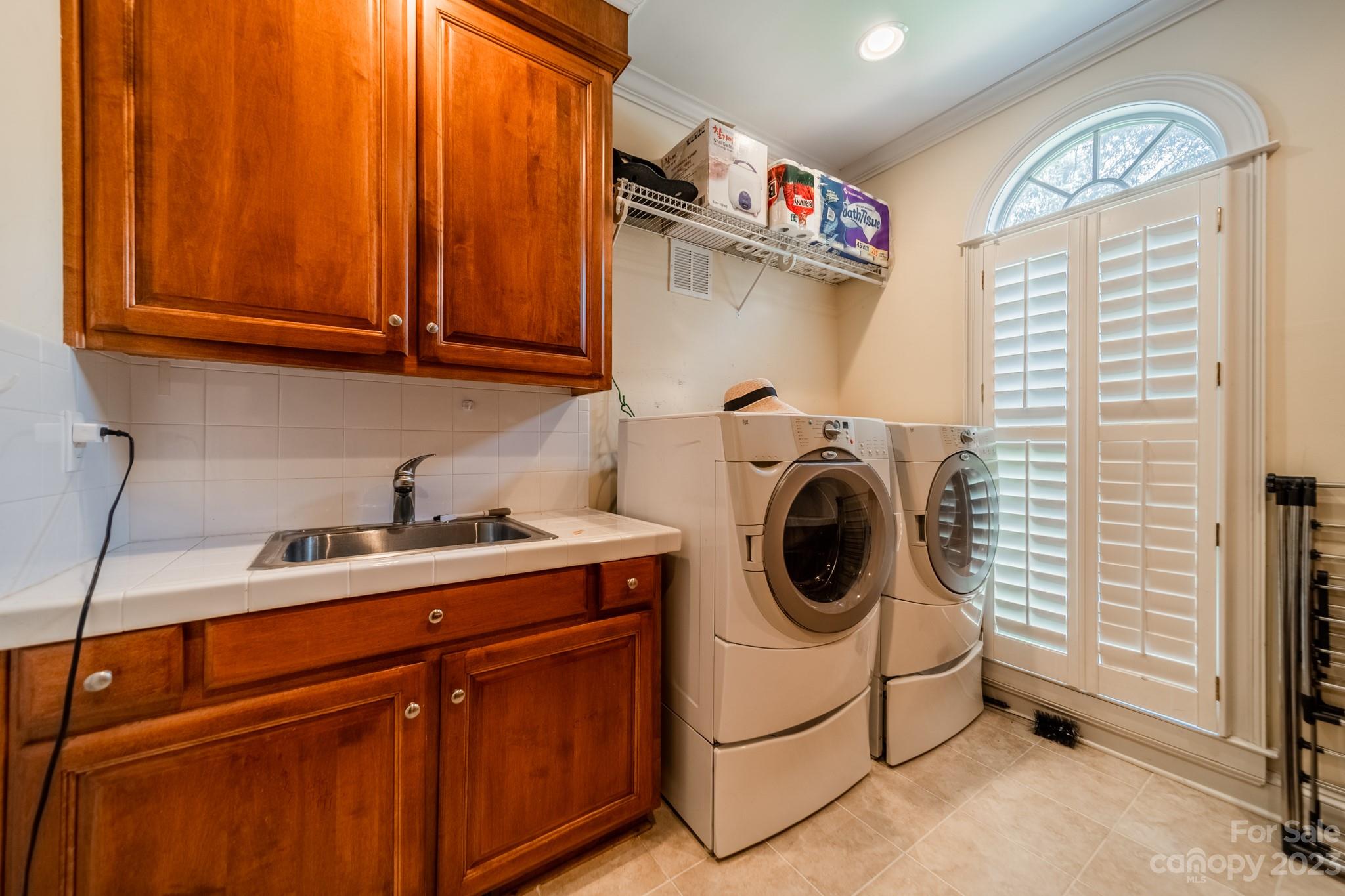 1439 Windy Ridge Road Charlotte, NC 28270 - Photo 39 of 46 a utility room with sink dryer and washer