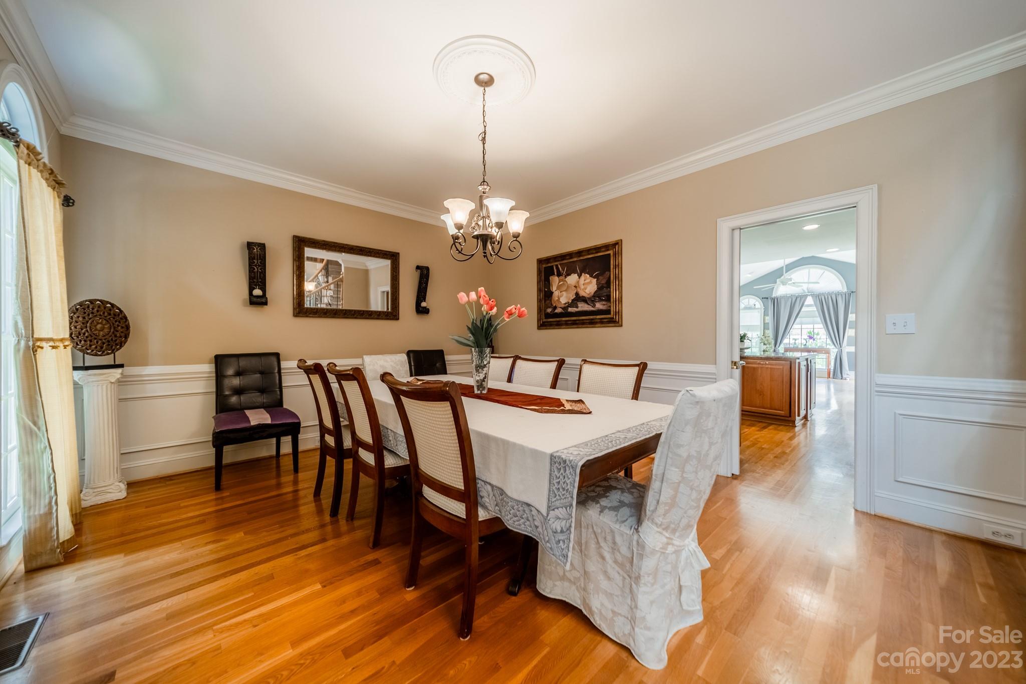 1439 Windy Ridge Road Charlotte, NC 28270 - Photo 8 of 46 a view of a dining room with furniture and chandelier