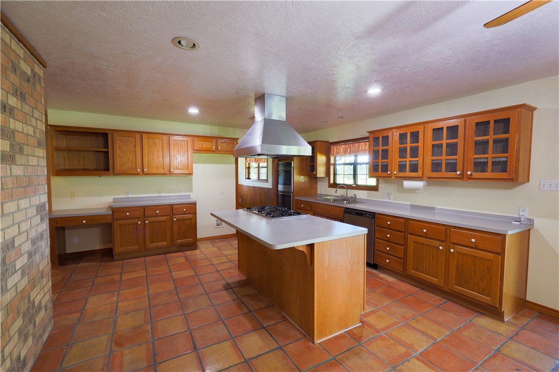16403-16515 Macey Road Hearne, TX 77859 - Photo 24 of 46 a kitchen with stainless steel appliances granite countertop a stove a sink and a microwave