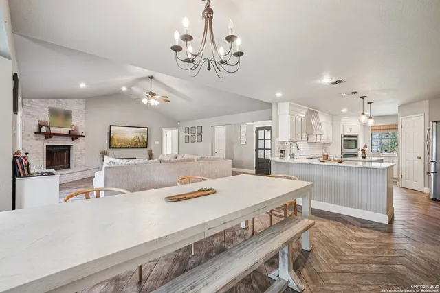a kitchen with granite countertop white cabinets stainless steel appliances and a sink