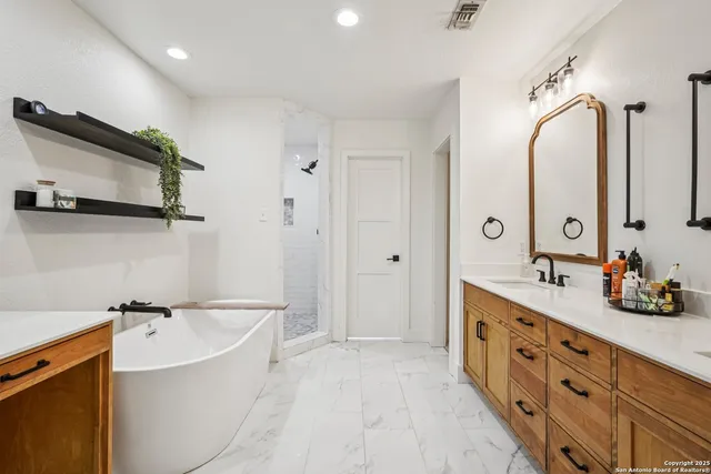 a view of a house with backyard and sitting area