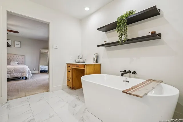 a view of a house with a yard potted plants and large tree