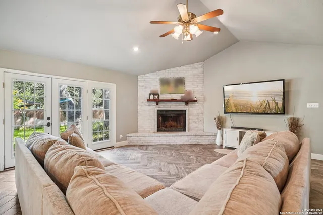 a living room with furniture and a view of kitchen