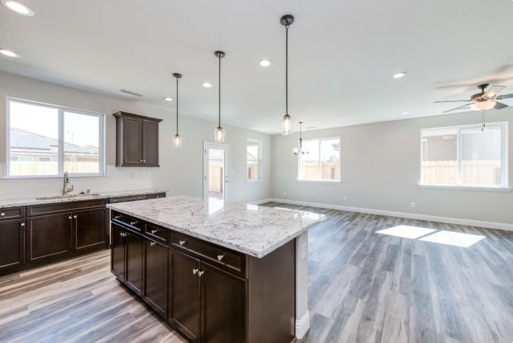 450 South Susan Avenue Kerman, CA 93630 - Photo 4 of 8 a kitchen with a granite countertop sink window and appliances