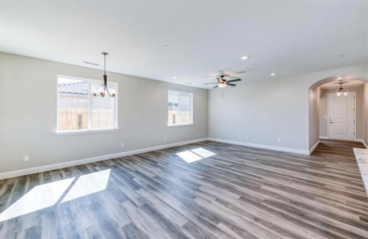 450 South Susan Avenue Kerman, CA 93630 - Photo 5 of 8 an empty room with wooden floor and windows