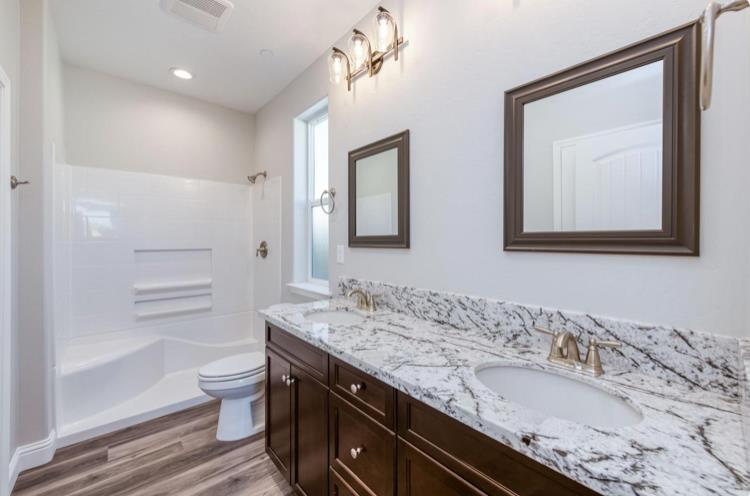 450 South Susan Avenue Kerman, CA 93630 - Photo 7 of 8 a bathroom with a granite countertop sink toilet and a mirror