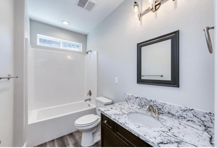 450 South Susan Avenue Kerman, CA 93630 - Photo 8 of 8 a bathroom with a sink a toilet and shower