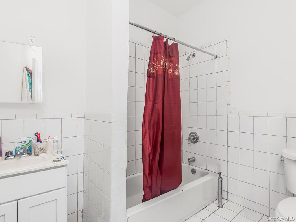 2108 Arthur Avenue Bronx, NY 10457 - Photo 11 of 12 a bathroom with a shower and a sink