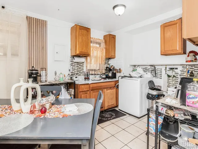 a view of a kitchen with kitchen island a sink a counter space and a window