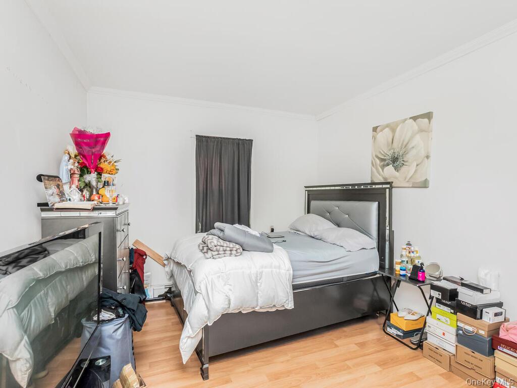 2108 Arthur Avenue Bronx, NY 10457 - Photo 4 of 12 a bedroom with a bed and a dresser