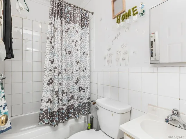 a bathroom with a toilet and a shower curtain