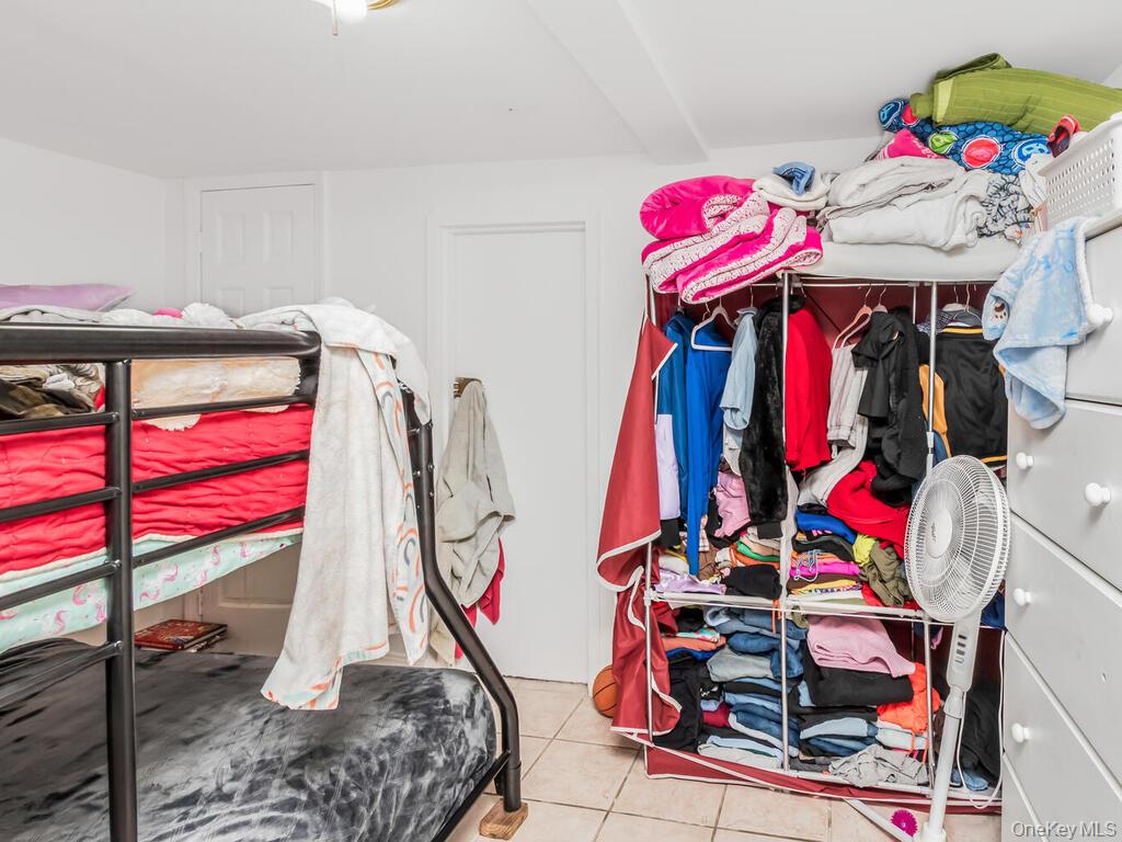 2108 Arthur Avenue Bronx, NY 10457 - Photo 10 of 12 a view of walk in closet with clothes