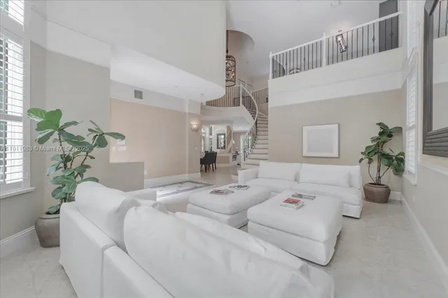 a living room with furniture flowerpot and a chandelier